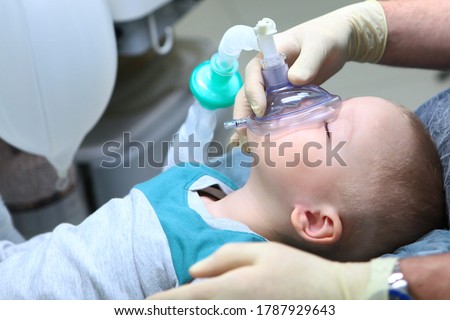 The child is under General anesthesia. Treatment of baby teeth.The device of artificial ventilation of lungs.Copy space.