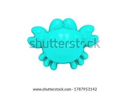 Beach toys: a light blue crab-shaped sand mold on a white background