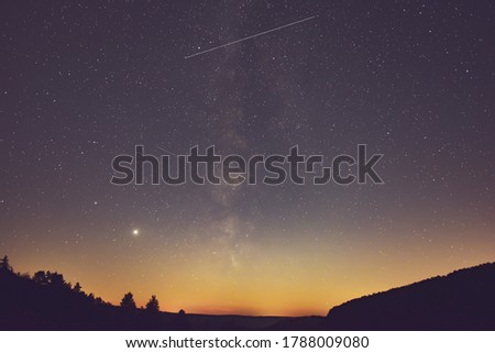 Milky Way and satellite  in the night.