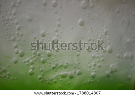 Blurry images of bubbles attaching to the plastic bucket wall of green beverage Caused to be beautiful fog and mist.