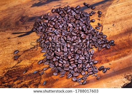 Close up to a heap of coffee beans.
Macro photography of fresh roasted coffee beans high resolution. Detailed macro picture on roasted coffee beans.  Close-up of brown coffee beans background  image