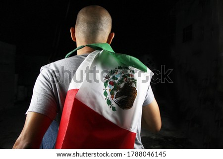 Mexican man holding the Mexican flag