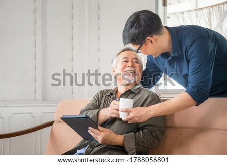 Cheerful senior asian father and middle aged son in living room, Happiness Asian family concepts Royalty-Free Stock Photo #1788056801