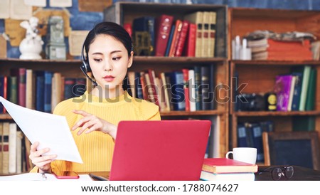 Working asian woman in the living room. Telemeeting. Video conference. Remote work. Royalty-Free Stock Photo #1788074627