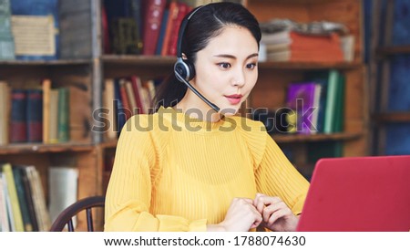 Working asian woman in the living room. Telemeeting. Video conference. Remote work. Royalty-Free Stock Photo #1788074630