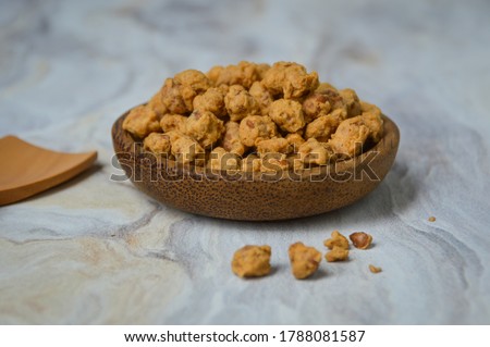 Kacang telur Medan or Medan Egg Beans are a nut-based snack with crispy flour mixed Royalty-Free Stock Photo #1788081587