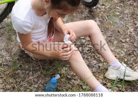 Portrait of a cute little girl of eight years old walks in the forest in nature