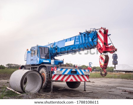 Construction site crane is lifting a led signboard Blank billboard on blue sky background for new advertisement