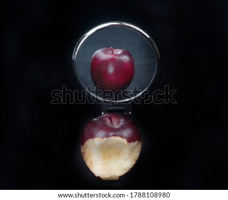 Bitten apple and perfect apple in the mirror is concept you are perfect in the social medias and not perfect in real life                Royalty-Free Stock Photo #1788108980