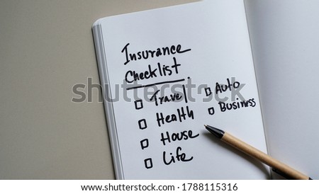 Insurance checklist on a notepad - business concept.
