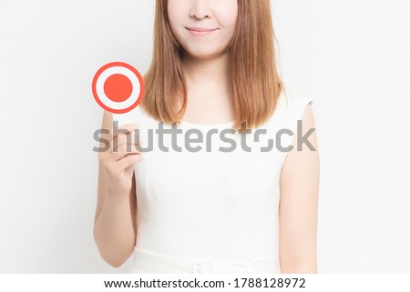 Young woman with an OK placard shot in the studio