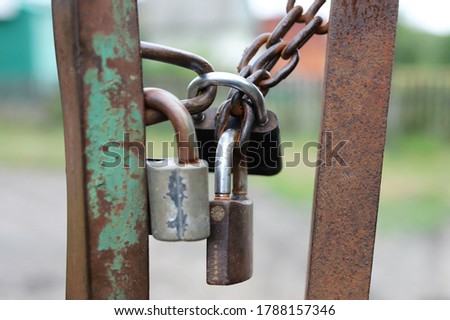 iron padlocks on closed gates