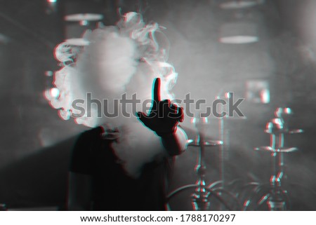 man smokes a hookah and lets out a cloud of smoke. Black and white with 3D glitch virtual reality effect
