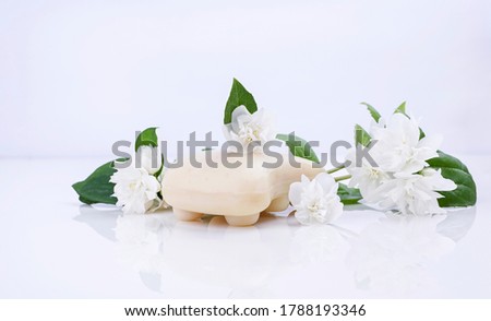 Handmade jasmine soap. Natural cosmetics for spa treatments and body care. Soap and fresh jasmine flowers on a white background. High quality photo