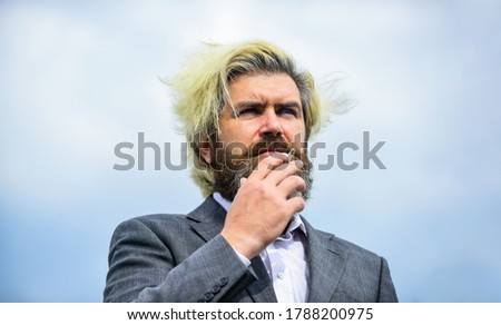 Breathe in and out. Smoking habit concept. Bearded hipster smoking outdoors. Smell of smoke. Handsome man smoke flying out of mouth. Cigarette tobacco. Smoking aesthetics. Personal crisis concept.