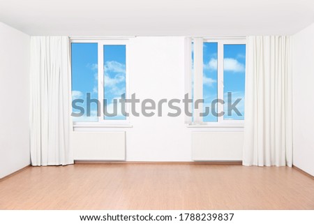 Beautiful view on blue sky with clouds through windows in room