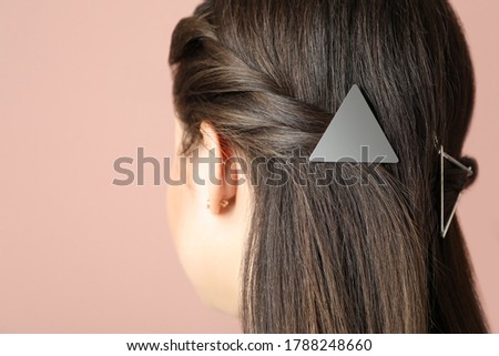 Young woman with beautiful hair clips on pink background, closeup