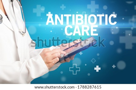 doctor writes notes on the clipboard with ANTIBIOTIC CARE inscription, first aid concept