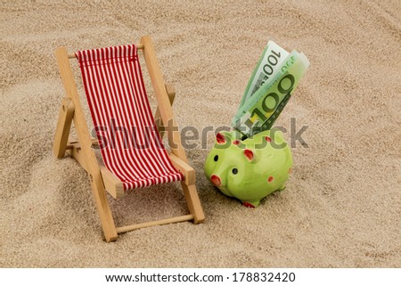 beach chair with euro currency on the sandy beach. symbolic photo for travel costs, vacation, holiday