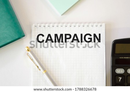 on the notebook is written the text campaign. High quality photo