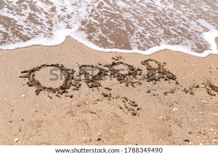 children's drawings on the sand on the sea