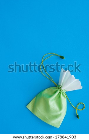 little green gift bag on blue background - natural greenery - trend color 2017