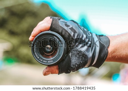 Lens in hand, during outdoor activities