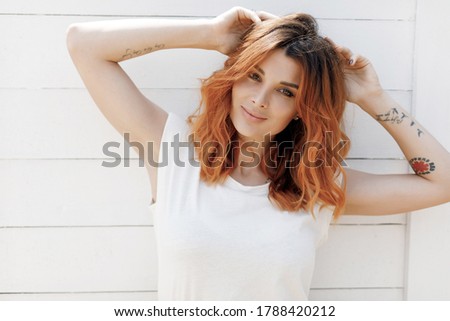 Young smiling happy ginger woman portrait outdoors