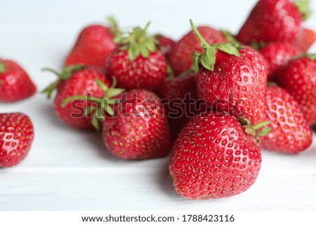 Delicious ripe strawberries on white wooden table, closeup