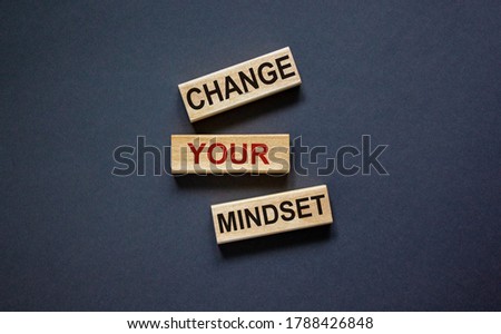 Wooden blocks form the text 'change your mindset' on beautiful black background. Business concept.