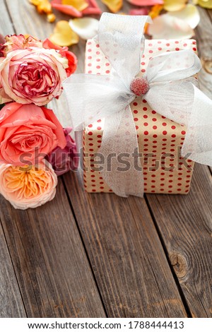 Gift box and fresh roses for Valentine's Day or women's day. Holiday concept