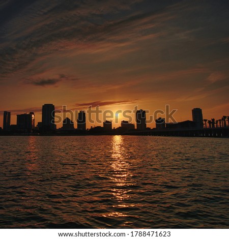 Sunset over St. Petersburg, Florida skyline from water.