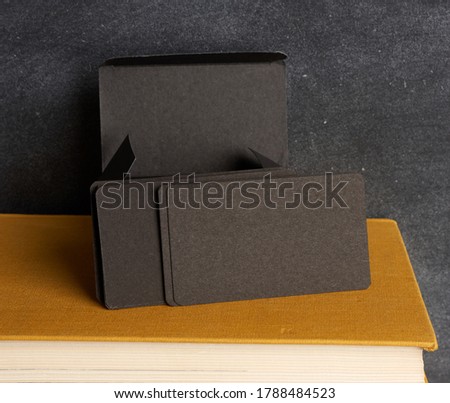 stack of rectangular black paper blank business cards, close up