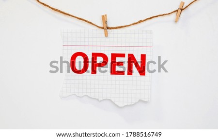 Open sign hanging in a shop window