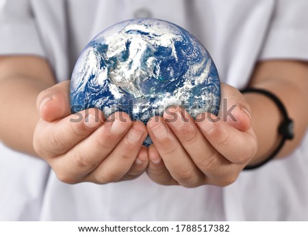 Environment day concept, Earth in child hands. Elements of this image furnished by NASA