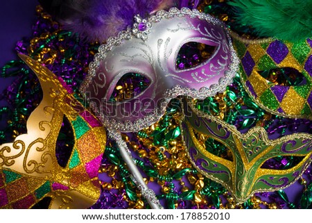 Festive Grouping of mardi gras, venetian or carnivale mask on a purple background Royalty-Free Stock Photo #178852010