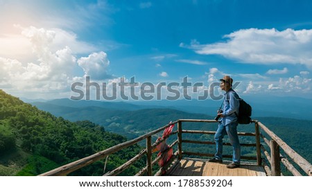 Tourists who stand to take pictures on the bridge to see the beautiful mountain and sky view at Moncham, Chiang Mai, Thailand