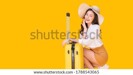 A beautiful Asian woman prepares to travel. She is very happy to relax on a summer holiday.