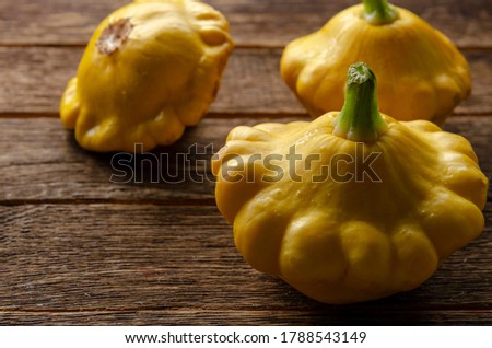 Yellow pattypan squash on the wooden table