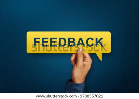 Hand holding the FEEDBACK written speech bubble. Service rating, satisfaction concept
