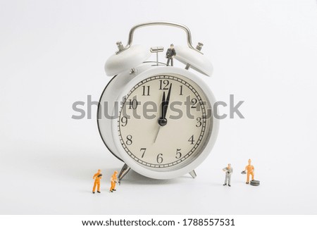 Alarm clock worker on white background