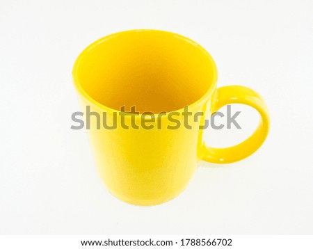 One yellow ceramic mug isolated on white background.
