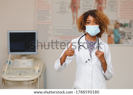 Young attractive african doctor with face mask