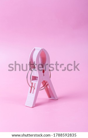 Large plastic clips on pink background