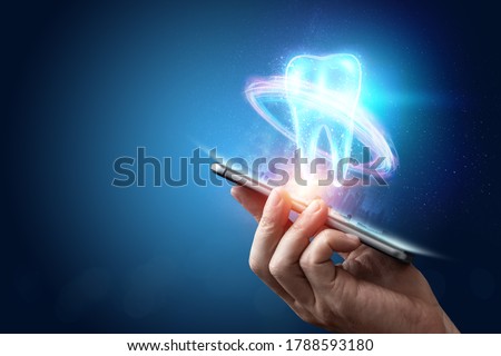 Image of a neon hologram tooth. Medicine concept, new technologies, oral care, dental prosthetics, copy space