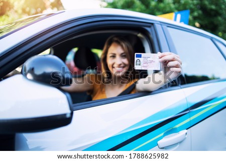 Woman with driving license. Driving school. Young beautiful woman successfully passed driving school test. Female smiling and holding driver's license. Royalty-Free Stock Photo #1788625982