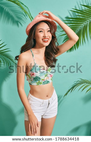 Happy woman wearing a summer clothes having fun isolated on bright blue background 