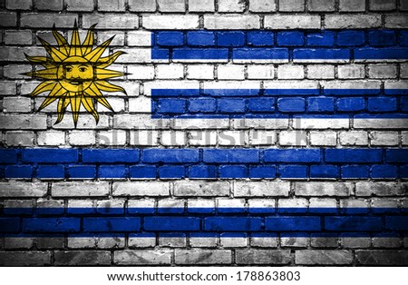 Brick wall with painted flag of Uruguay
