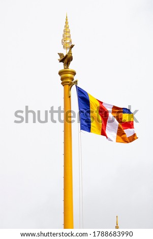 Buddhist flag hanging with pole over white background, Cambodia
