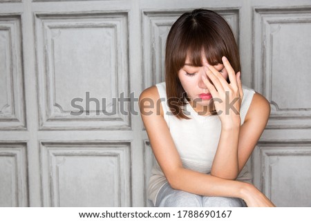 A woman is holding her head. Royalty-Free Stock Photo #1788690167